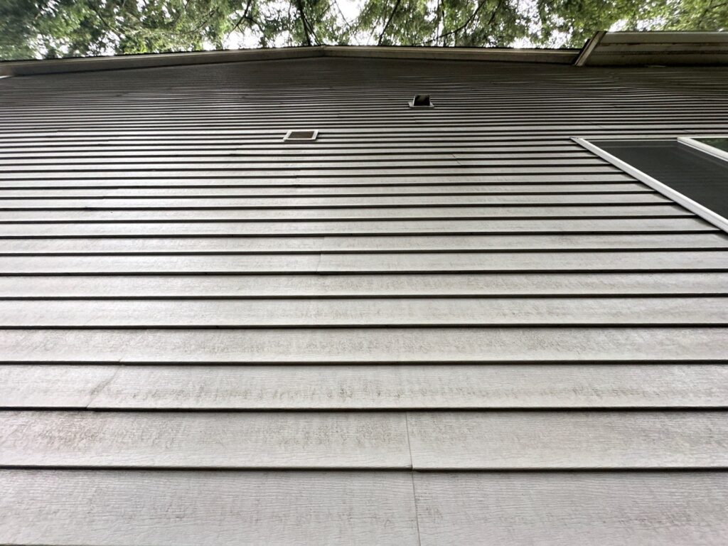 Fall house washing in September removing summer grime from siding