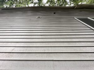 Fall house washing in September removing summer grime from siding