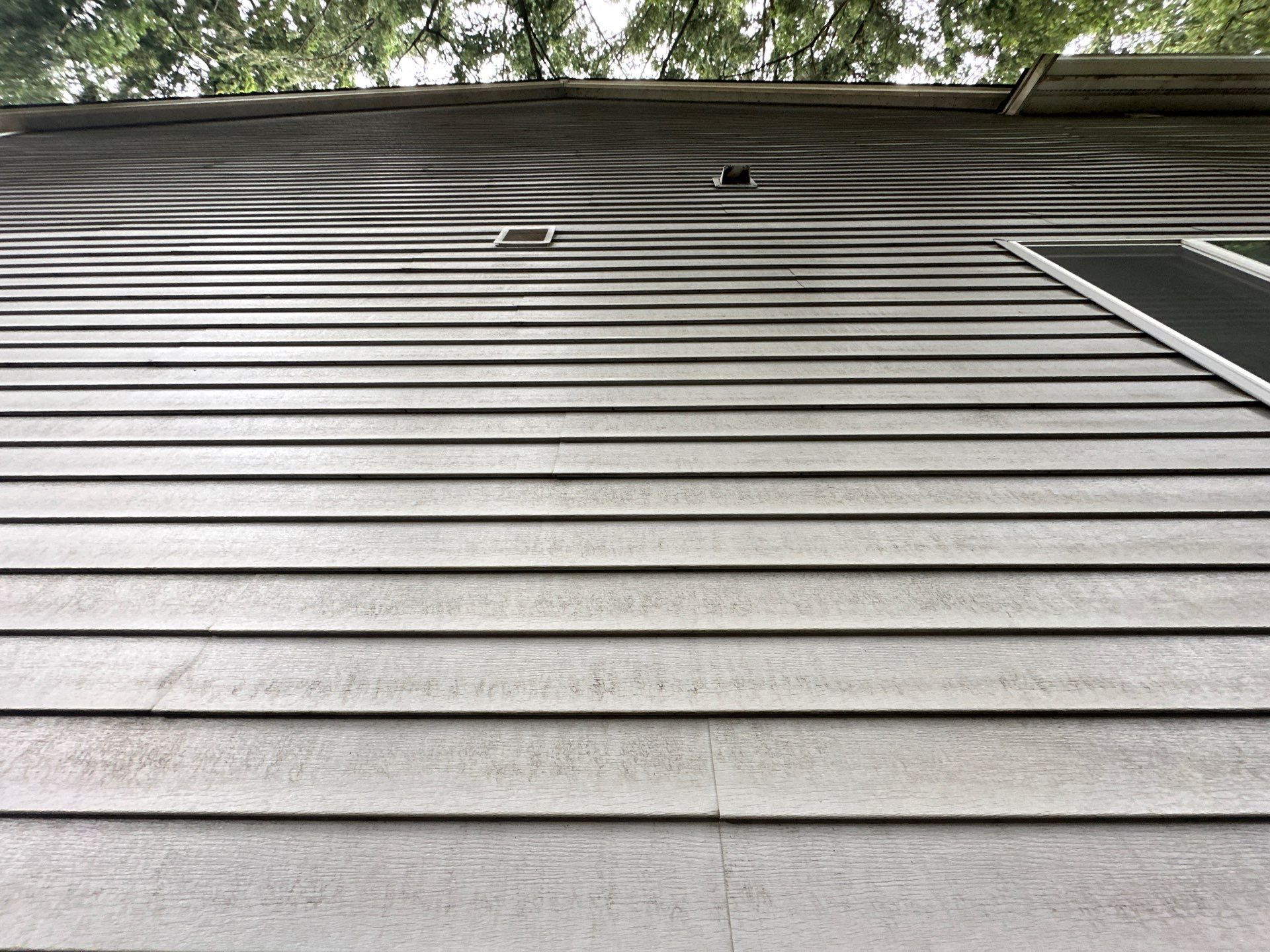 Fall house washing in September removing summer grime from siding