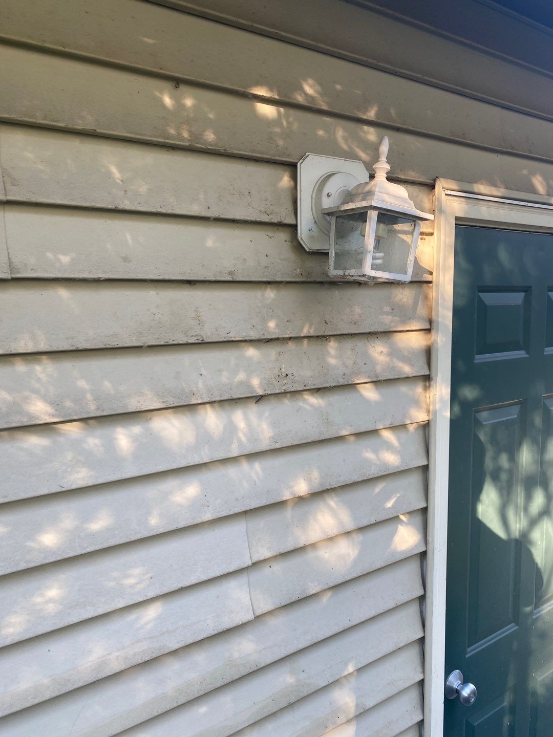 Late summer house washing removing grime from siding